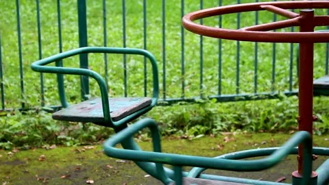 Old rusty playground merry go round spinning in an abandoned park Stock Footage 346795465