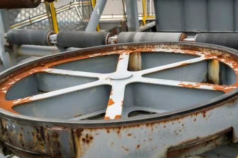 Old rusty power wheel of an assembly belt Stock Photos