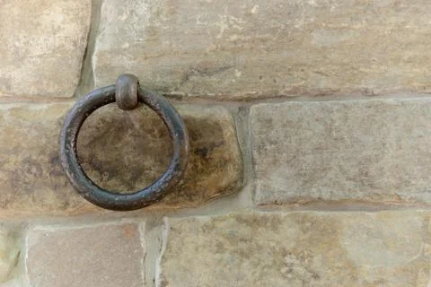 Old rusty ring fixed in a stone brick wall Stock Photos