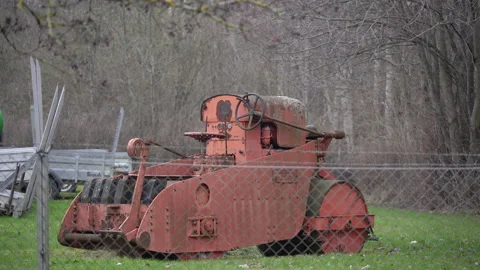 Old rusty road roller behind fence on open area. Stock Footage 335402864