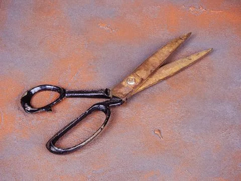 Old rusty scissors on an orange background Stock Photos