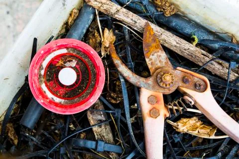 Old rusty secateurs and a plastic reel Stock Photos