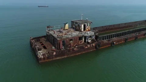 An old, rusty, semi-flooded barge in the water. Aerial view. Stock Footage 85633954