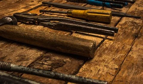 An old rusty set of hand tools on a wooden background. Stock Photos