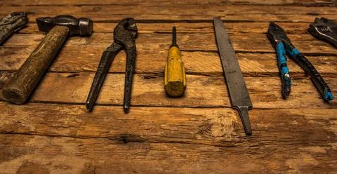 An old rusty set of hand tools on a wooden background. Stock Photos