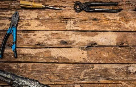 An old rusty set of hand tools on a wooden background. Stock Photos