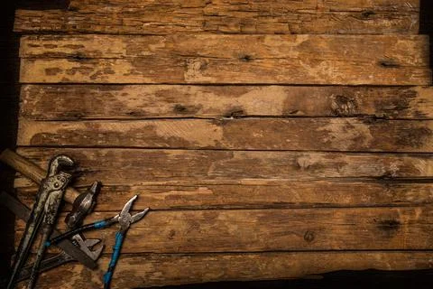 An old rusty set of hand tools on a wooden background. Stock Photos