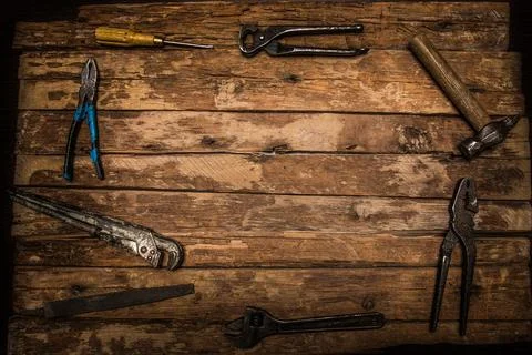 An old rusty set of hand tools on a wooden background. Stock Photos