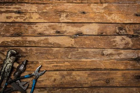An old rusty set of hand tools on a wooden background. Stock Photos
