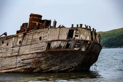 An old rusty ship is now floating gently in the water today Stock Photos