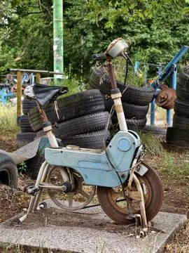 Old rusty Soviet exercise bicycle standing outdoors on a sports area for ca.. Stock Photos
