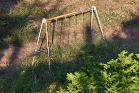 Old rusty swing on an abandoned site Stock Photos