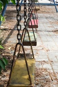 Old rusty swing at the playground Stock Photos