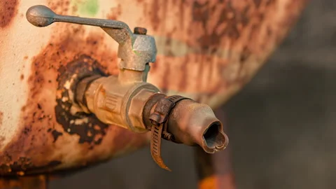 Old rusty tap from which a drop of fuel flows Video stock 136541565