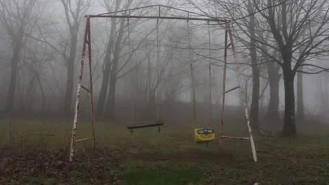 Old rusty teeter totter in a scary evil horror atmosphere with fog and mist 스톡 동영상 158328413
