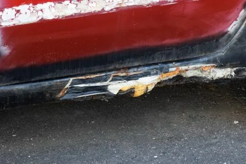 Old rusty threshold of a red car Stock Photos