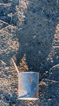 Old rusty tin can lying on the sand Stock Photos