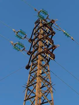 Old rusty tower (phylon) of a power delivery overhead line Stock Photos
