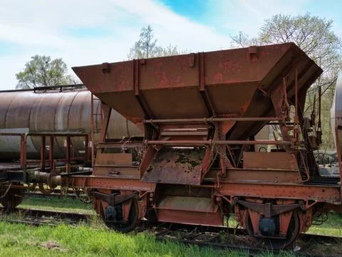 Old rusty train wagon for transporting cargo on a railway in a field of grass Stock-Fotos