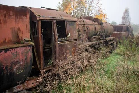 Old rusty trains. Old abandoned track, siding with dirty old trains. Stock Photos