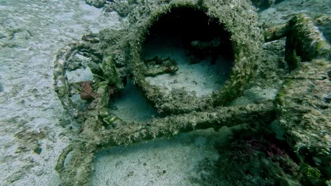An old, rusty underwater structure covered in marine growth at the ocean Stock Footage 286109883