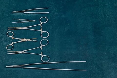 Old, rusty, used surgical instruments on a blue background, close up Stock Photos