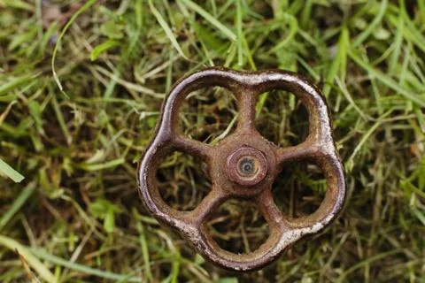 Old rusty valve in the grass Stock Photos