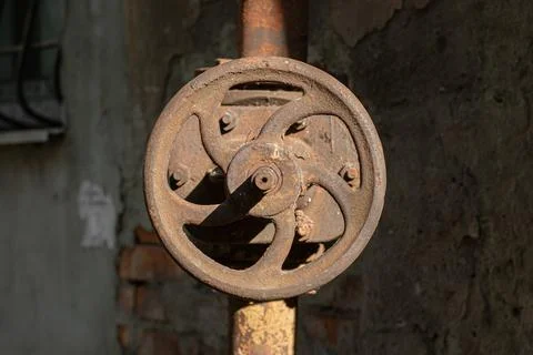 Old rusty valve on an old rusty pipe, close-up. Stock Photos