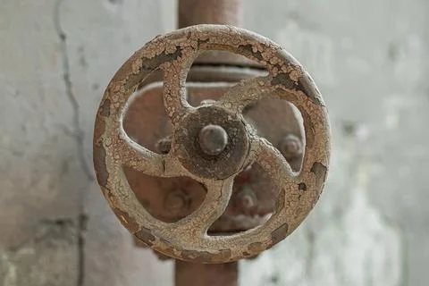 Old rusty valve on an old rusty pipe, close-up. Stock Photos
