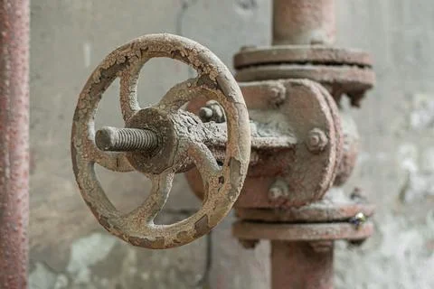 Old rusty valve on an old rusty pipe, close-up. Stock Photos