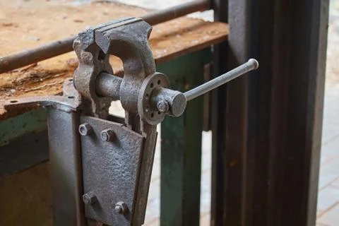 Old rusty vise on iron table in workshop Stock Photos
