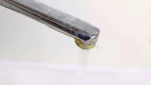 Old rusty water tap is open and a strong stream of water flows into the bath. Stock Footage 188047167