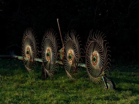 Old rusty Wheel Rake or Cart rake in the field Stock Photos