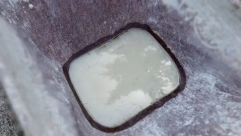 Old rusty wheelbarrow with liquid cement solution debris on construction site Stock Footage 228944114