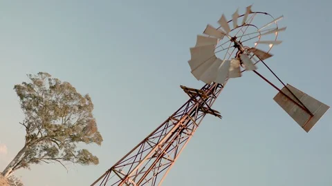 Old rusty windmill on farm sunset colours dutch tilt with sound 動画素材 94327997