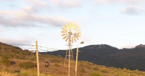Old rusty windmill near a road in the mountains wind renewable energy 動画素材 87467697