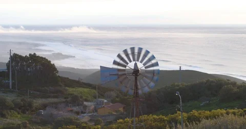 Old rusty windmill near a road in the mountains beach wind renewable energy 動画素材 87468158