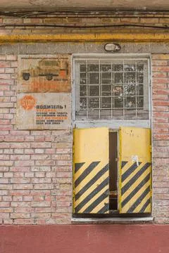 Old rusty window on the wall of the house for receiving postal goods Stock Photos