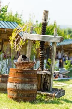 Old rusty wine press with oak barrel. Stock Photos