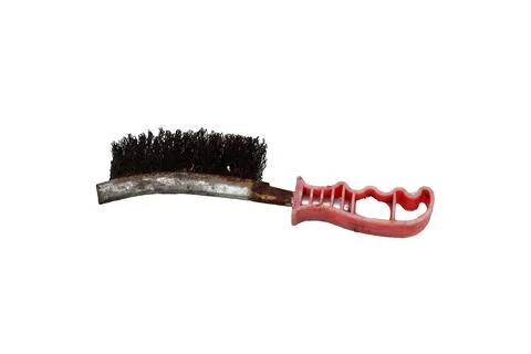 Old rusty wire brush with a pink plastic handle on a white background Foto stock