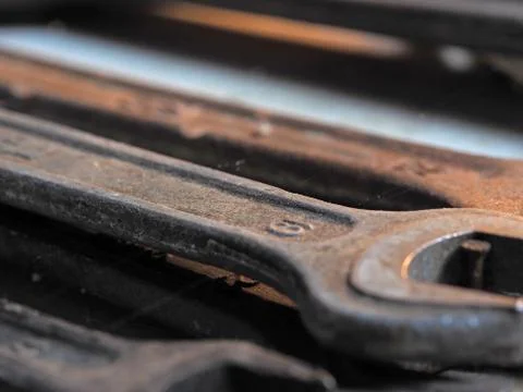 Old rusty wrenches close-up with blurred background. Tool concept Stock Photos