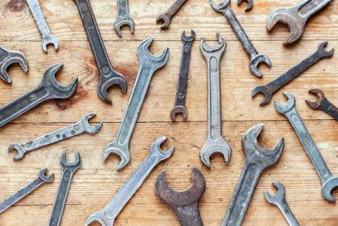 Old rusty wrenches flat lay on wooden background Stock Photos