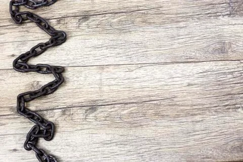 Old rusty zigzag shape chain on background. Stock Photos