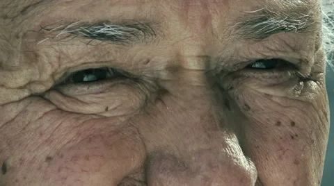 Old sad man closeup portrait on his eyes: 780s retired man looks  Stock Footage 58303556