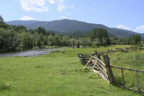An old sagging hedge and river on the edge of village in the Altai Mountains Stock Photos
