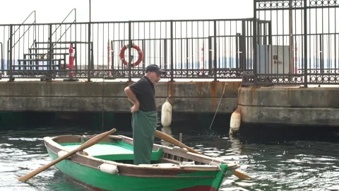 Old sailor rowing and docking his small boat, 4K, DNxHR Stock Footage 151077724