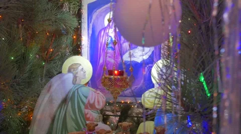An Old Saint Mary Icon Under a Decorated Fir Tree in an Orthodox Cathedral With Stock Footage 58922601