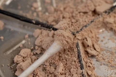 Old scattered broken cosmetics, makeup powder , dust and large pieces of wome Stock Photos