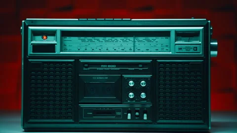Old school tape machine resting inside workspace. Analog switches playback knobs Stock Footage 332365291