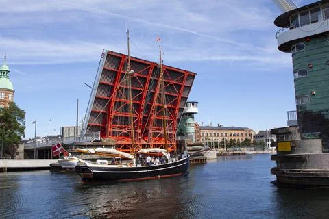 Old schooner ship passing through an open drawbridge Stock Photos